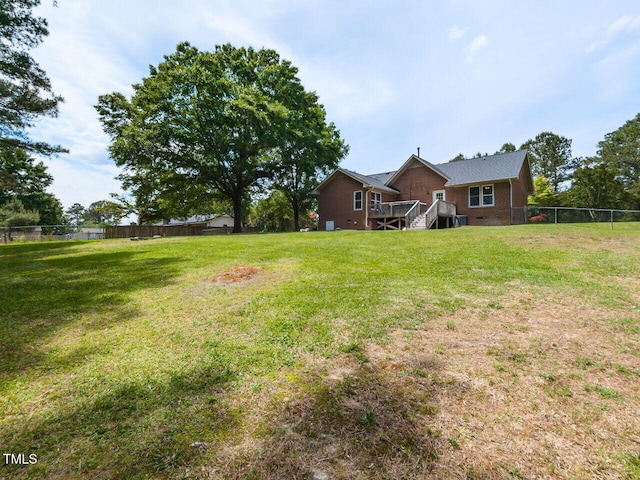 view of yard featuring a deck and stairway