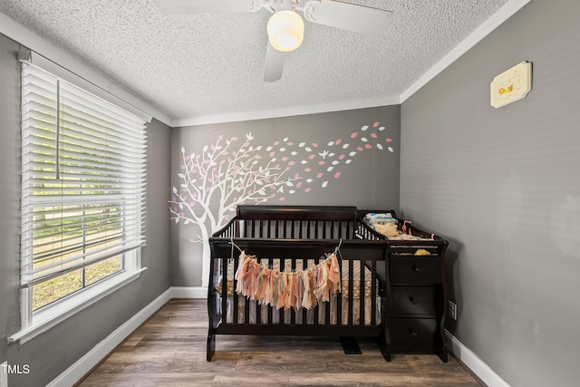 109 Winding Creek Dr, Youngsville, NC 27596 - bedroom featuring a textured ceiling, a ceiling fan, wood finished floors, baseboards, and crown molding