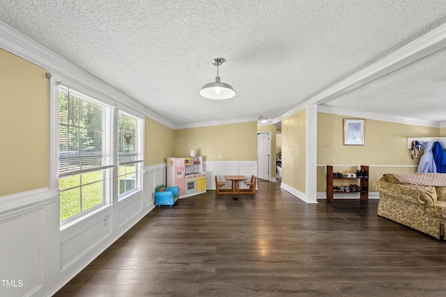 109 Winding Creek Dr, Youngsville, NC 27596 - playroom featuring a textured ceiling, ornamental molding, healthy amount of natural light, a wainscoted wall, and dark wood-style floors