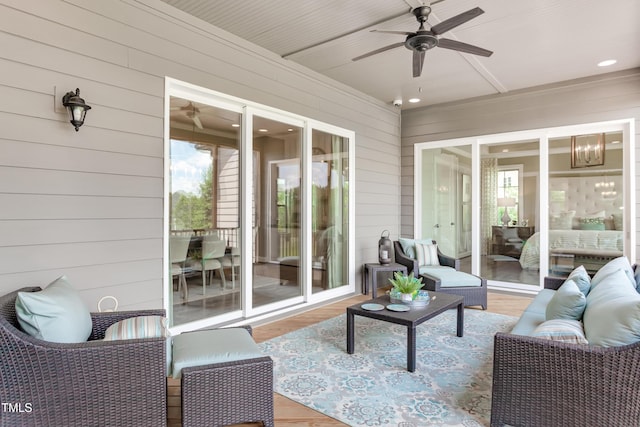 sunroom / solarium featuring ceiling fan, an outdoor living space, and healthy amount of natural light