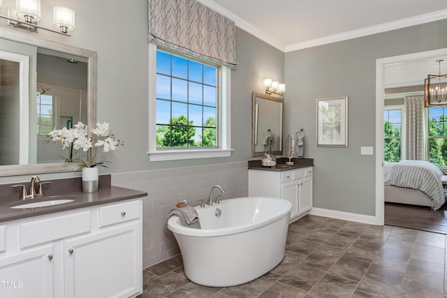 bathroom featuring ornamental molding, healthy amount of natural light, a freestanding tub, tile walls, and connected bathroom