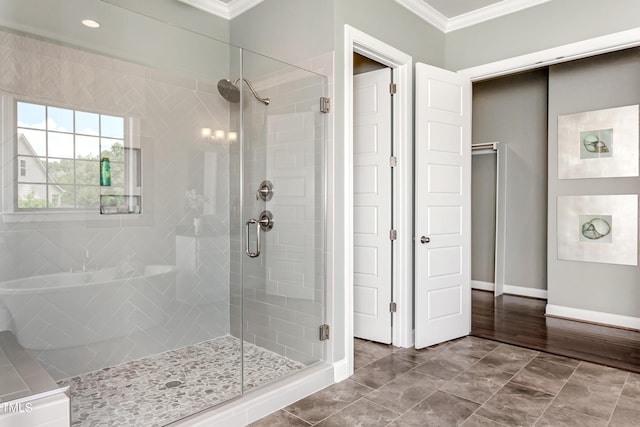 bathroom with crown molding, a stall shower, baseboards, and recessed lighting
