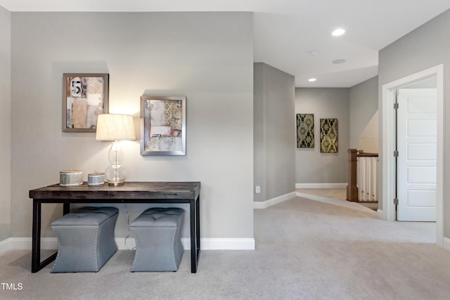 hallway featuring an upstairs landing, carpet, baseboards, and recessed lighting