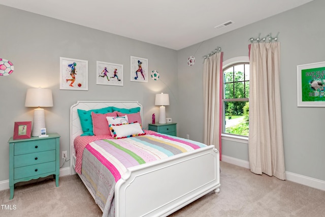 bedroom with light colored carpet and baseboards