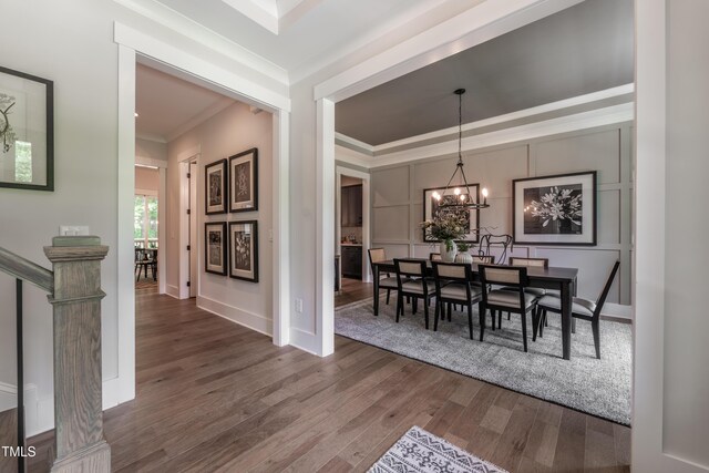 318 Ivy Ridge Rd, Chapel Hill, NC 27516 - dining area featuring crown molding, wood finished floors, a chandelier, and baseboards