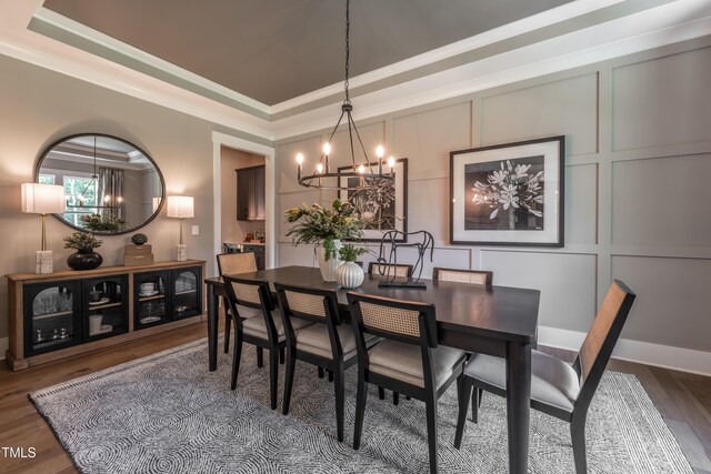 318 Ivy Ridge Rd, Chapel Hill, NC 27516 - dining room with a chandelier, wood finished floors, a tray ceiling, ornamental molding, and a decorative wall