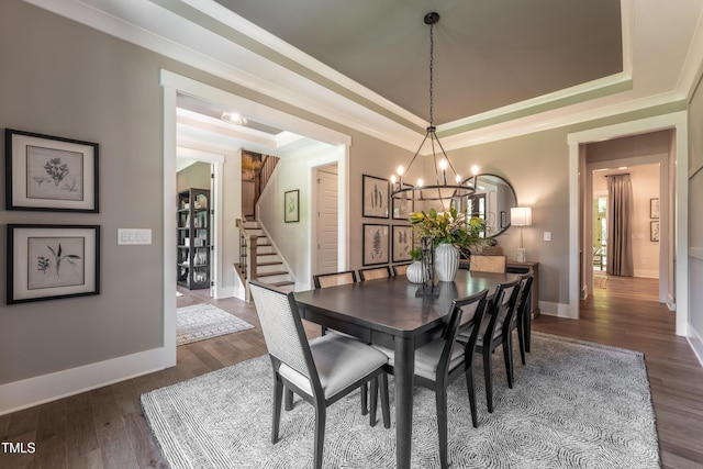 318 Ivy Ridge Rd, Chapel Hill, NC 27516 - dining space featuring a chandelier, a raised ceiling, stairway, crown molding, and dark wood-style flooring