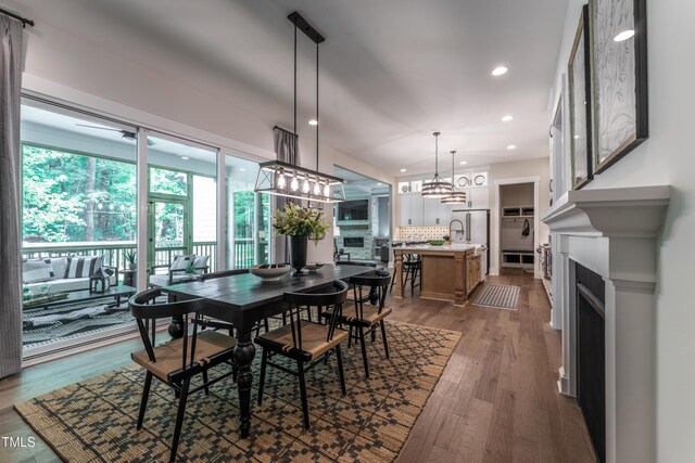 318 Ivy Ridge Rd, Chapel Hill, NC 27516 - dining area featuring recessed lighting, dark wood-style flooring, a fireplace, and a chandelier