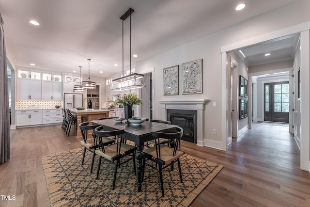318 Ivy Ridge Rd, Chapel Hill, NC 27516 - dining area with a glass covered fireplace, recessed lighting, baseboards, wood finished floors, and crown molding