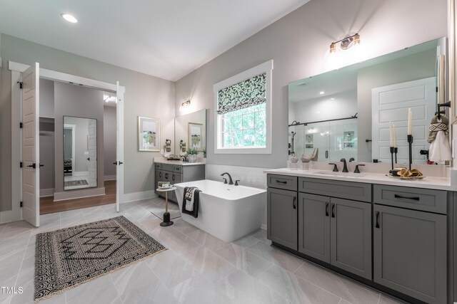 318 Ivy Ridge Rd, Chapel Hill, NC 27516 - full bathroom featuring a stall shower, a freestanding bath, two vanities, and baseboards