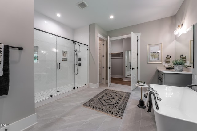 318 Ivy Ridge Rd, Chapel Hill, NC 27516 - full bathroom featuring a shower stall, a freestanding bath, vanity, recessed lighting, and a spacious closet