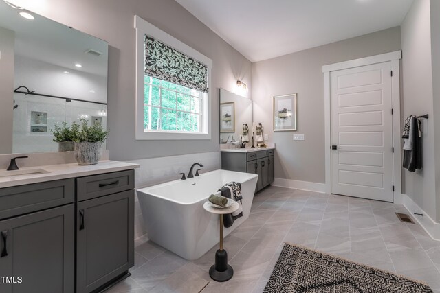 318 Ivy Ridge Rd, Chapel Hill, NC 27516 - full bathroom featuring a freestanding tub, two vanities, baseboards, a shower, and recessed lighting