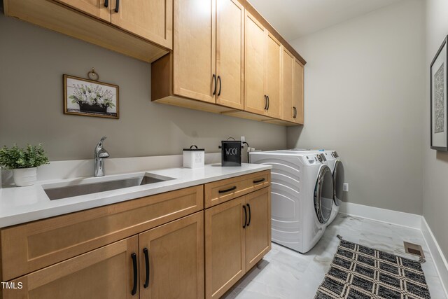 318 Ivy Ridge Rd, Chapel Hill, NC 27516 - laundry area with cabinet space, washer and clothes dryer, light marble finish flooring, and baseboards
