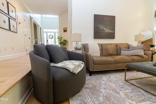 living room featuring ornamental molding and baseboards