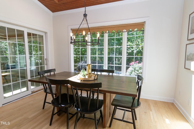dining area with crown molding, light wood-style floors, baseboards, and a chandelier
