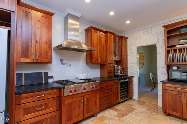 kitchen with beverage cooler, wall chimney range hood, crown molding, stainless steel gas stovetop, and backsplash