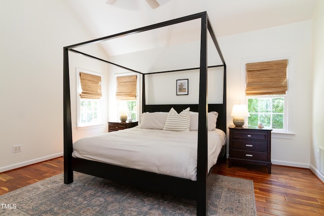 bedroom featuring hardwood / wood-style floors, baseboards, lofted ceiling, and a ceiling fan