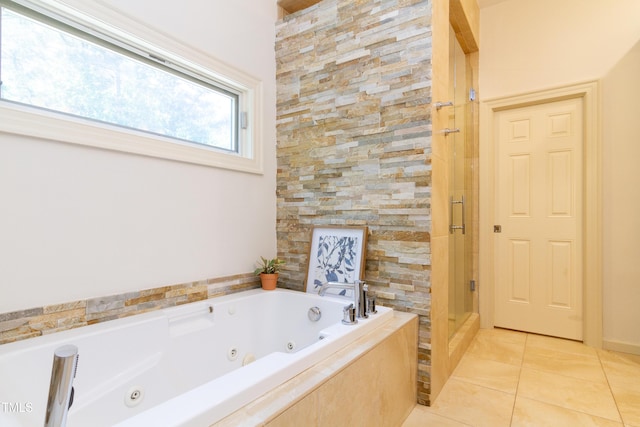 full bathroom with a shower stall, a jetted tub, and tile patterned flooring