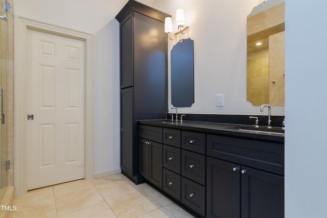 bathroom featuring a shower stall, double vanity, and tile patterned floors