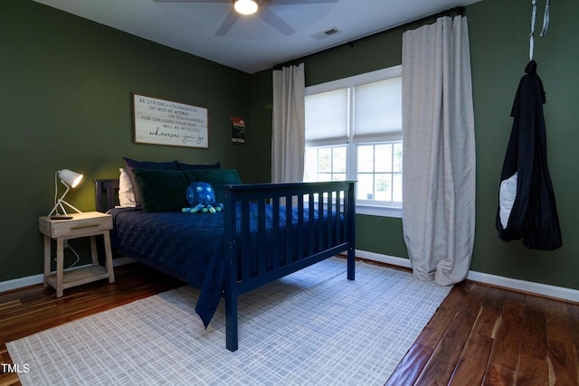 bedroom with baseboards, wood finished floors, and ceiling fan