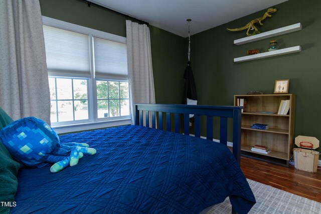 bedroom featuring wood finished floors