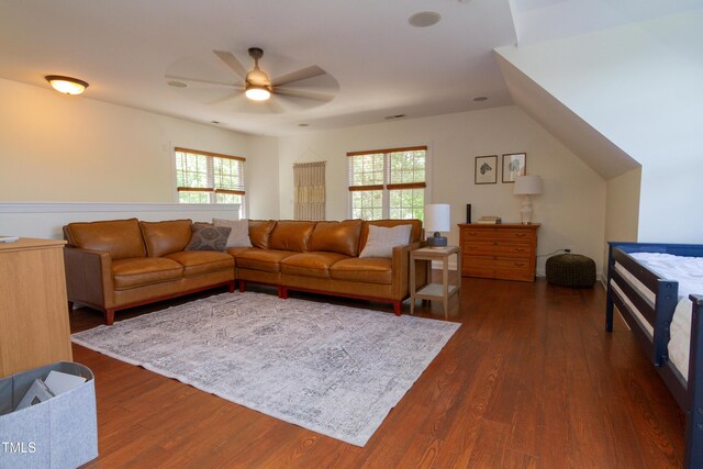 living area with a ceiling fan and dark wood-style floors