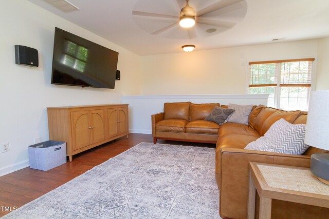 living area with wood finished floors, ceiling fan, and baseboards