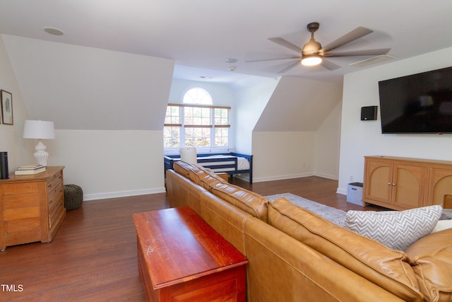 living room featuring dark wood-type flooring, vaulted ceiling, baseboards, and a ceiling fan