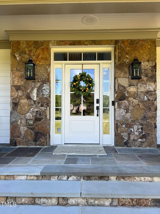 doorway to property with stone siding