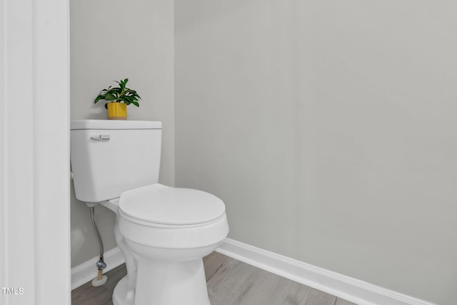 8820 Waynick Dr, Raleigh, NC 27617 - bathroom with baseboards, toilet, and wood finished floors