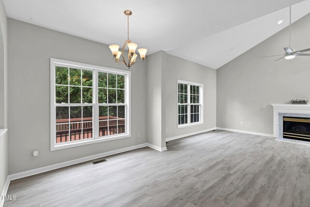 8820 Waynick Dr, Raleigh, NC 27617 - unfurnished living room featuring a chandelier, wood finished floors, baseboards, a ceiling fan, and lofted ceiling