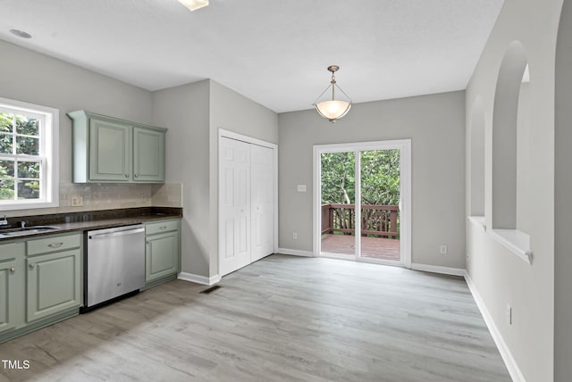 8820 Waynick Dr, Raleigh, NC 27617 - kitchen with dishwasher, green cabinetry, dark countertops, light wood-style flooring, and baseboards