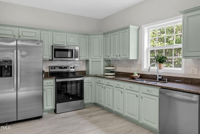 8820 Waynick Dr, Raleigh, NC 27617 - kitchen featuring stainless steel appliances, a sink, tasteful backsplash, and dark stone countertops