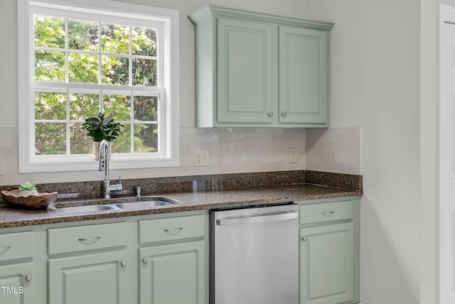 8820 Waynick Dr, Raleigh, NC 27617 - kitchen with stainless steel dishwasher, a sink, and tasteful backsplash