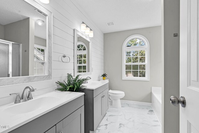 8820 Waynick Dr, Raleigh, NC 27617 - full bath featuring wood walls, a stall shower, marble finish floors, two vanities, and toilet