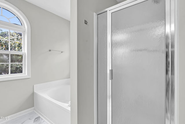 8820 Waynick Dr, Raleigh, NC 27617 - full bathroom featuring marble look tile flooring, a bath, a shower stall, and plenty of natural light