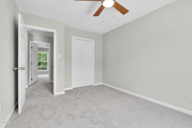 8820 Waynick Dr, Raleigh, NC 27617 - unfurnished bedroom featuring carpet floors, baseboards, a closet, a ceiling fan, and attic access