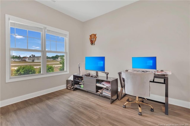 home office featuring wood finished floors and baseboards