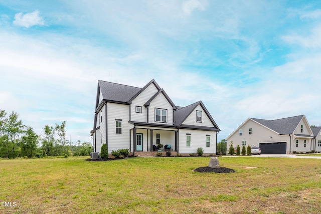 474 Pine Ridge Rd, Zebulon, NC 27597 - modern farmhouse style home featuring covered porch, a front yard, central AC, and an attached garage