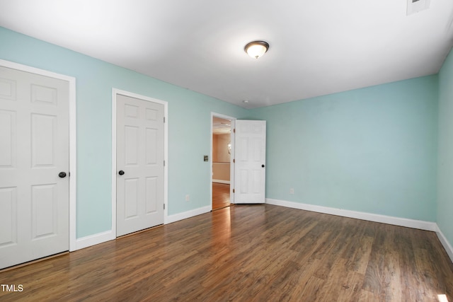 1005 Temple St, Raleigh, NC 27609 - unfurnished bedroom featuring wood finished floors and baseboards