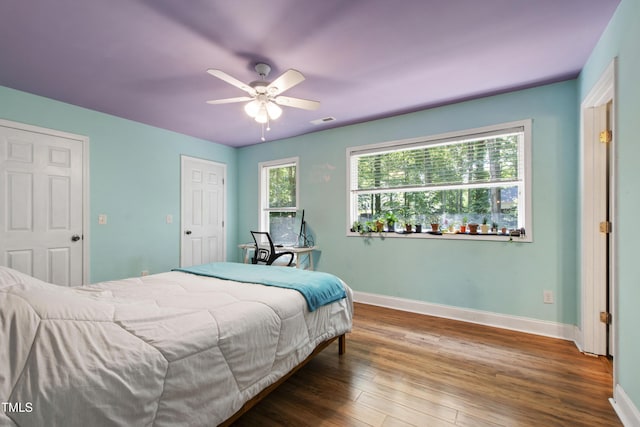 1005 Temple St, Raleigh, NC 27609 - bedroom with baseboards, wood finished floors, and ceiling fan