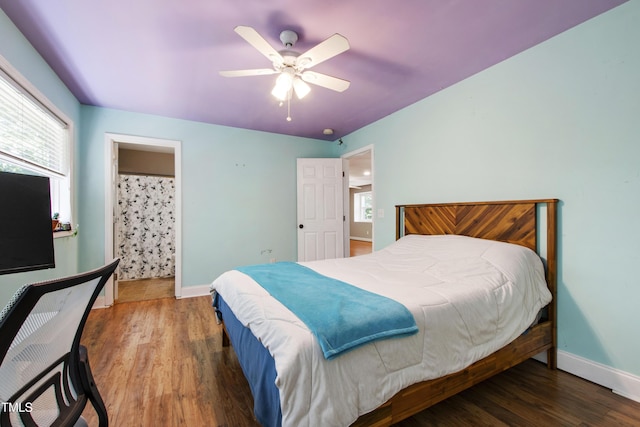 1005 Temple St, Raleigh, NC 27609 - bedroom with baseboards, wood finished floors, a ceiling fan, and connected bathroom