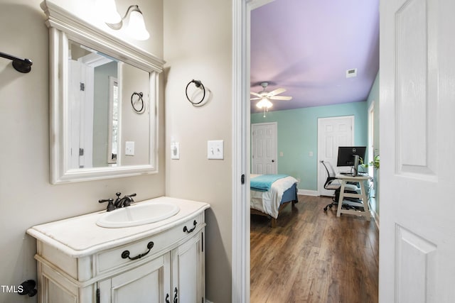 1005 Temple St, Raleigh, NC 27609 - bathroom with wood finished floors, vanity, and ceiling fan