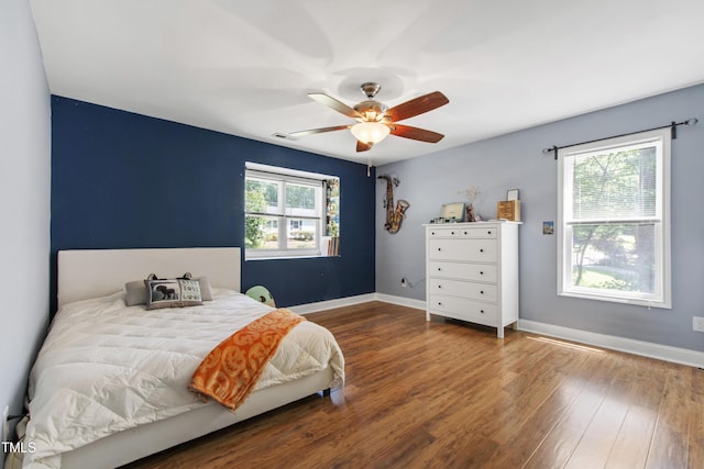 1005 Temple St, Raleigh, NC 27609 - bedroom with wood finished floors, baseboards, and ceiling fan