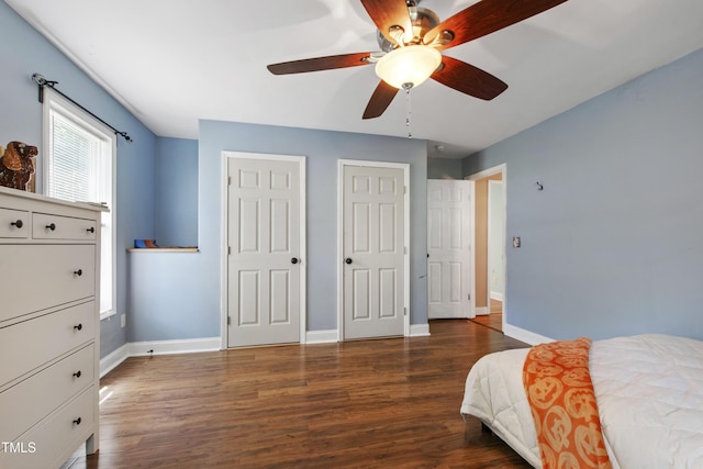 1005 Temple St, Raleigh, NC 27609 - bedroom featuring wood finished floors, two closets, baseboards, and a ceiling fan