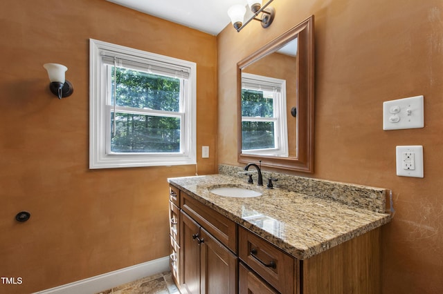 1005 Temple St, Raleigh, NC 27609 - bathroom with plenty of natural light, vanity, and baseboards