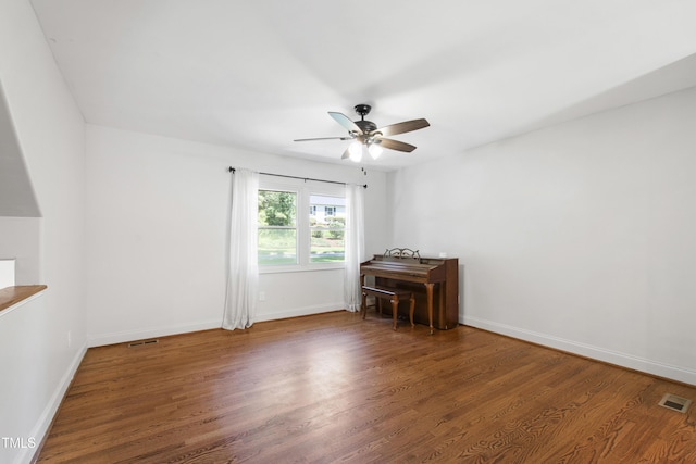 1005 Temple St, Raleigh, NC 27609 - spare room featuring ceiling fan, wood finished floors, and baseboards