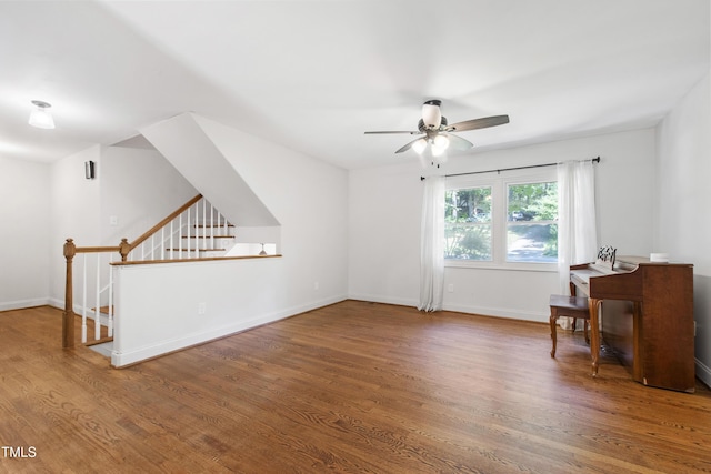 1005 Temple St, Raleigh, NC 27609 - unfurnished living room featuring wood finished floors, a ceiling fan, and baseboards