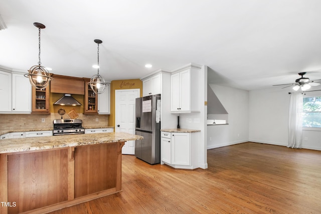 1005 Temple St, Raleigh, NC 27609 - kitchen with appliances with stainless steel finishes, wall chimney range hood, glass insert cabinets, light stone countertops, and baseboards