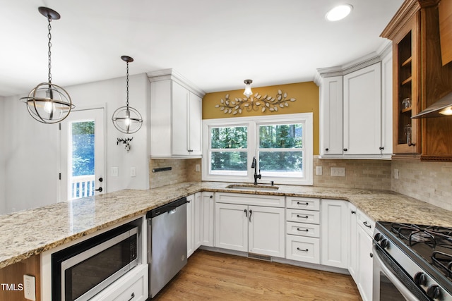 1005 Temple St, Raleigh, NC 27609 - kitchen with appliances with stainless steel finishes, a chandelier, a sink, and healthy amount of natural light